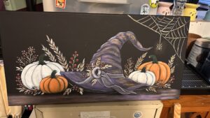 Halloween Painting of a witch's hat and pumpkins